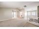 Spacious second floor loft featuring neutral walls, carpet, white railing, and natural light from the shuttered windows at 170 Wicked Wedge Way, Las Vegas, NV 89148