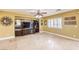 Bright living room with tile flooring, built-in shelving, and plantation shutters at 170 Wicked Wedge Way, Las Vegas, NV 89148