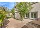 Private side yard features a brick patio and mature trees at 170 Wicked Wedge Way, Las Vegas, NV 89148