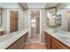 Bright bathroom featuring double sinks and a walk-in shower with neutral colors at 1729 Yellow Rose St, Las Vegas, NV 89108