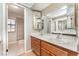 Well-lit bathroom with double vanity, framed mirrors, and a tiled walk-in shower at 1729 Yellow Rose St, Las Vegas, NV 89108
