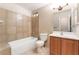 Bright bathroom with a shower-tub combo, toilet, and modern vanity at 1729 Yellow Rose St, Las Vegas, NV 89108