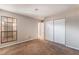 Bedroom featuring carpeted floors, a large window, and built-in closet storage at 1729 Yellow Rose St, Las Vegas, NV 89108