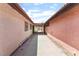Side yard features concrete pathway and desert landscaping at 1729 Yellow Rose St, Las Vegas, NV 89108