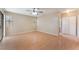 Spacious living room with wood-look flooring, natural light, and a ceiling fan at 1729 Yellow Rose St, Las Vegas, NV 89108