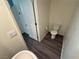 This half bathroom features tile flooring and a white toilet at 1906 Arietta Vista St, Henderson, NV 89044