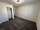 A carpeted bedroom features a closet, an open door to a hallway, and neutral walls at 1906 Arietta Vista St, Henderson, NV 89044