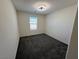 A carpeted bedroom features a window, a ceiling fan with lights, and neutral walls at 1906 Arietta Vista St, Henderson, NV 89044