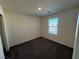 A carpeted bedroom has natural light from the window and neutral colored walls at 1906 Arietta Vista St, Henderson, NV 89044