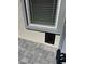 Close-up of an exterior window with a pet door installed beneath at 1906 Arietta Vista St, Henderson, NV 89044