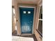 A vibrant blue front door is framed by stucco walls and a brick walkway at 1906 Arietta Vista St, Henderson, NV 89044