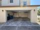 A spacious garage has storage shelves on the ceiling and blue trash bins at 1906 Arietta Vista St, Henderson, NV 89044