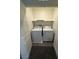 A laundry closet includes a white washer and dryer with a shelf above the appliances at 1906 Arietta Vista St, Henderson, NV 89044