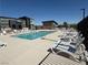 Community pool with several lounge chairs and neighborhood buildings in the background on a clear day at 1906 Arietta Vista St, Henderson, NV 89044