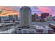 Stunning aerial view of the condo building with surrounding city landscape under a colorful sunset at 200 W Sahara Ave # 603, Las Vegas, NV 89102