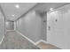 Clean, well-lit hallway leading to unit with neutral wall colors and textured floors at 200 W Sahara Ave # 603, Las Vegas, NV 89102