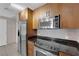 The kitchen features stainless steel appliances, granite countertops, and wood cabinets at 200 W Sahara Ave # 603, Las Vegas, NV 89102