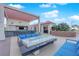 Stylish outdoor kitchen and lounge area with comfortable seating, a bar, and a fire pit at 200 W Sahara Ave # 603, Las Vegas, NV 89102