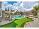 Stunning backyard boasts a sparkling pool, putting green, lush landscaping, and ample space for outdoor fun at 2959 Azure Bay St, Las Vegas, NV 89117