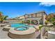 Captivating backyard showcasing a pool, spa, covered patio, and lush landscaping, perfect for outdoor living at 2959 Azure Bay St, Las Vegas, NV 89117