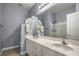 Well-lit bathroom with double sinks, white cabinets, and a large mirror at 2959 Azure Bay St, Las Vegas, NV 89117