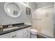 Stylish bathroom featuring a sleek vanity, round mirror, and glass-enclosed shower at 2959 Azure Bay St, Las Vegas, NV 89117