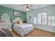 Light-filled bedroom with shuttered arched window, ceiling fan, and comfortable decor at 2959 Azure Bay St, Las Vegas, NV 89117