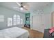 Inviting bedroom features a ceiling fan, TV, and shuttered arched window at 2959 Azure Bay St, Las Vegas, NV 89117