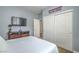 Comfortable bedroom with mounted TV, double closet, and neutral decor at 2959 Azure Bay St, Las Vegas, NV 89117