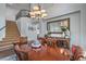 Formal dining room with hardwood table, chairs, large mirror and view of the stairway at 2959 Azure Bay St, Las Vegas, NV 89117