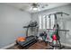 This home offers a dedicated exercise room with hardwood floors, natural light, and workout equipment at 2959 Azure Bay St, Las Vegas, NV 89117