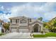 Charming two-story home featuring a stone-accented facade, three-car garage, and well-maintained landscaping at 2959 Azure Bay St, Las Vegas, NV 89117