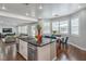 Modern open kitchen featuring granite countertops, stainless steel appliances and dark wood flooring at 2959 Azure Bay St, Las Vegas, NV 89117