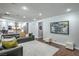 Spacious living room with hardwood flooring, modern furniture, and access to the kitchen at 2959 Azure Bay St, Las Vegas, NV 89117