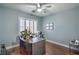 Home office offers hardwood floors, a modern desk, and shuttered windows at 2959 Azure Bay St, Las Vegas, NV 89117