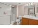 Cozy bathroom featuring a glass door shower, toilet, and vanity with a sink at 3125 N Buffalo Dr # 1103, Las Vegas, NV 89128