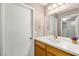 Bathroom featuring a wide mirror, vanity with sink, and white doors at 3125 N Buffalo Dr # 1103, Las Vegas, NV 89128