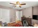 Bedroom with a ceiling fan, wood floors, and dresser for storage at 3125 N Buffalo Dr # 1103, Las Vegas, NV 89128