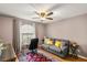 Cozy bedroom features neutral walls, fan, and a comfy gray couch at 3125 N Buffalo Dr # 1103, Las Vegas, NV 89128