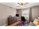 Bedroom with ceiling fan, dresser, and an inviting workspace near the window at 3125 N Buffalo Dr # 1103, Las Vegas, NV 89128