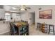 Breakfast bar and dining area adjacent to kitchen with white cabinets at 3125 N Buffalo Dr # 1103, Las Vegas, NV 89128