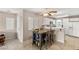 Inviting dining area featuring a wooden table and chairs next to the bright, white kitchen at 3125 N Buffalo Dr # 1103, Las Vegas, NV 89128