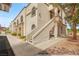 Building exterior with landscaped walkway, stairs to upper units, and desert landscaping at 3125 N Buffalo Dr # 1103, Las Vegas, NV 89128