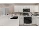Well-lit kitchen features white countertops and cabinetry, creating a clean, modern look at 3125 N Buffalo Dr # 1103, Las Vegas, NV 89128