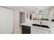 Bright kitchen showcasing a sink with bar, dishwasher and view into the living area at 3125 N Buffalo Dr # 1103, Las Vegas, NV 89128