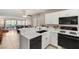 Open-concept kitchen features white cabinets and modern appliances with a view to the living room at 3125 N Buffalo Dr # 1103, Las Vegas, NV 89128