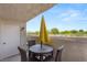 Charming patio with a yellow umbrella providing shade over a small table and chairs at 3125 N Buffalo Dr # 1103, Las Vegas, NV 89128