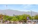 Street view of the property showing lush landscaping and a picturesque American flag at 3125 N Buffalo Dr # 1103, Las Vegas, NV 89128