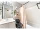 Bathroom with white tiled shower/tub and modern fixtures plus a trendy black commode at 3145 Tarpon Dr, Las Vegas, NV 89120