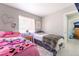 Bedroom featuring two beds, soft natural light, and neutral colored walls at 3145 Tarpon Dr, Las Vegas, NV 89120